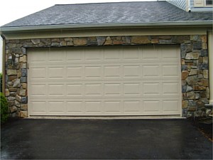 Garage of house with natural stone veneer